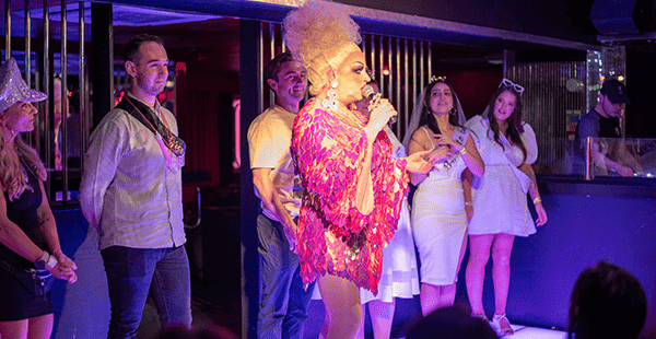 Adonis Drag Queen With Guests On Stage